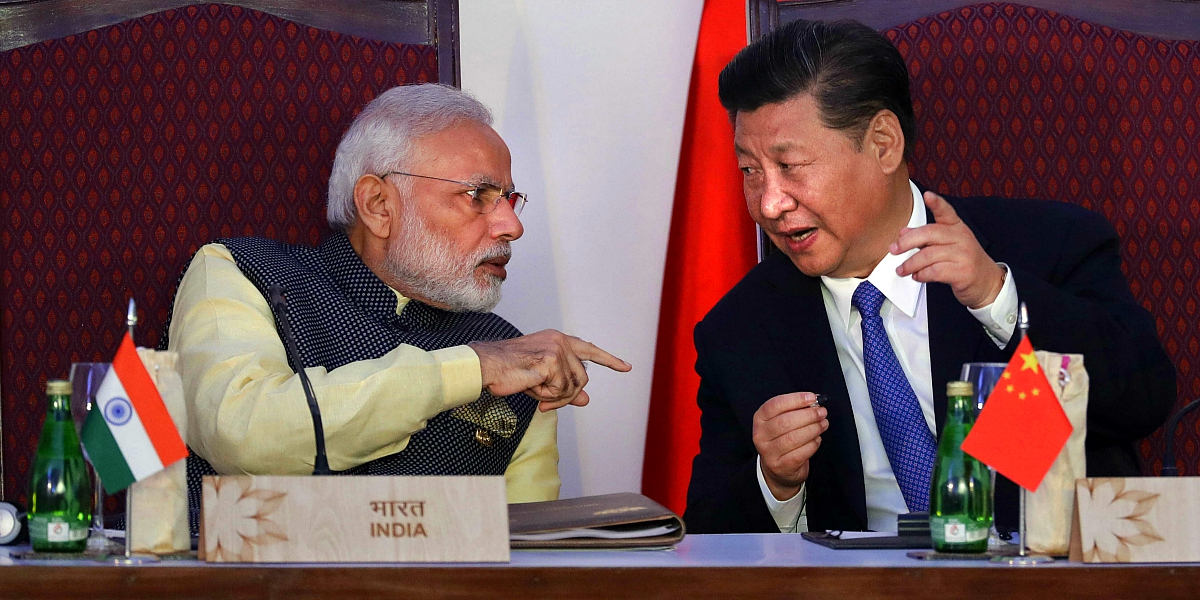 Indian Prime Minister Narendra Modi, left, talks with Chinese President Xi Jinping at the signing ceremony by foreign ministers during the BRICS summit in Goa, India, Sunday, Oct. 16, 2016. The leaders of five of the world's fast-rising powers were meeting Sunday in the southwestern Indian state of Goa for their annual summit at a time when their ability to shape the global dialogue on international politics and finance is increasingly being questioned. (AP Photo/Manish Swarup)