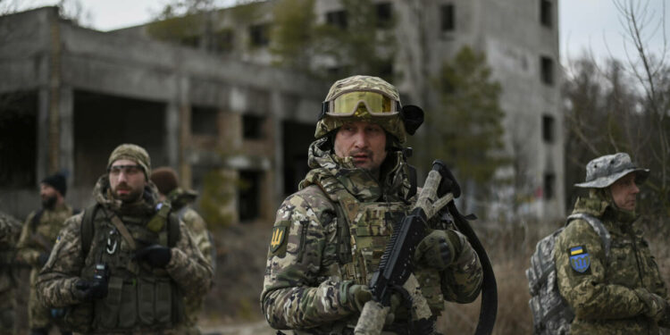 Ukrainian civilian volunteers and reservists of the Kyiv Territorial Defense unit conduct weekly combat training in an abandoned asphalt factory on the outskirts of Kiev, as Russian forces continue to mobilize en masse on the Ukrainian border. Kiev, Ukraine, February 19, 2022. (Photo by Justin Yau/Sipa USA)(Sipa via AP Images)